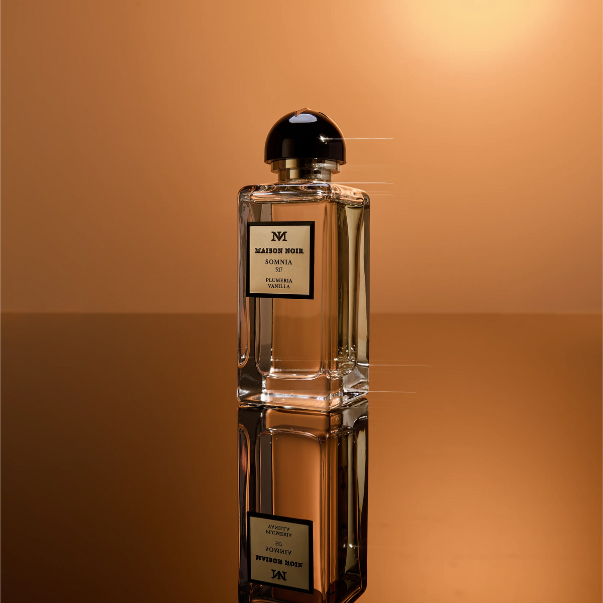A single Maison Noir flacon standing against a warm amber ground